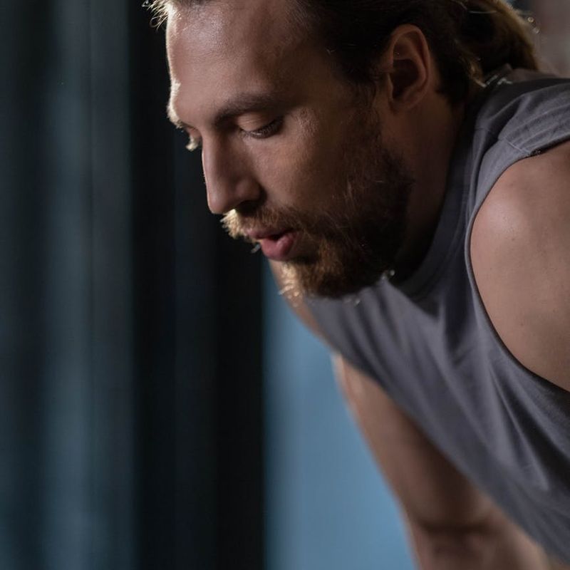 Close-up of a man's focused face during a workout.